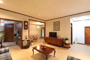 a living room with a couch and a table at Imah Budi Luhur in Bandung