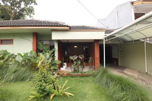 a house with a garden in front of it at Imah Budi Luhur in Bandung