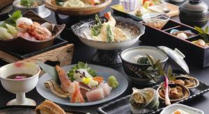 a table topped with plates of food and bowls of food at Ikadasou Sanjou in Shima
