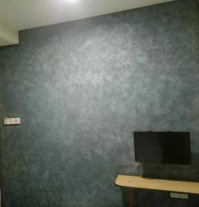 a wall with a television on a table in a room at Hotel Tuaran in Kota Kinabalu +41 photos