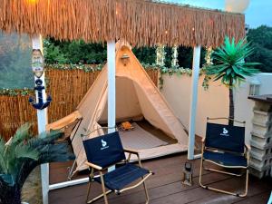 two chairs and a tent on a deck at La Solis in Incheon