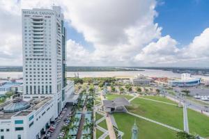 an aerial view of a city with a tall building at RH Hotel Sibu in Sibu