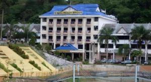 a large white building with a blue roof at Lipis Plaza Hotel in Kuala Lipis