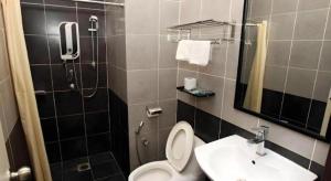 a bathroom with a toilet and a sink and a mirror at Uptown Imperial Kajang in Kampong Sungai Kantan +21 photos