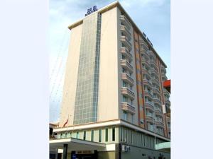 a tall building with a lot of windows at MB Hotel in Tawau