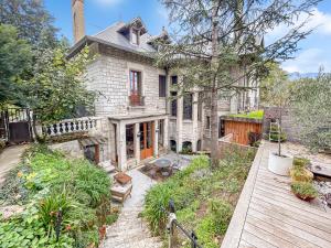 an old stone house with a garden in front of it at Grand T4 Luxe, SPA, Cheminée Baby-foot, Jardin in Aix-les-Bains