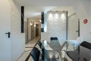 a dining room with a glass table and chairs at Mount Pilatus Rooms Lucerne in Luzern +27 photos