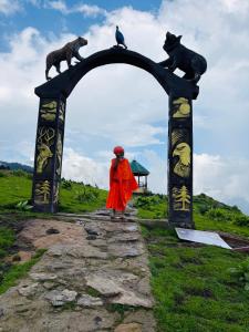 a woman standing under an arch with animals on it at Krishna home stay in Tārna