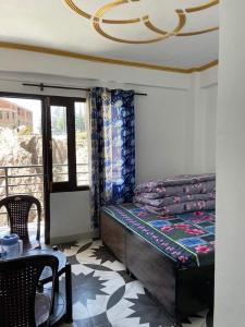 a bedroom with a bed and a table and a window at Krishna home stay in Tārna