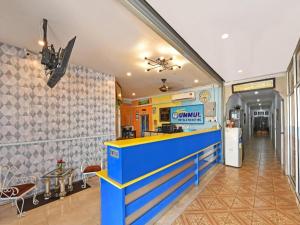 a restaurant with a blue counter in a room at Hotel O Ummul Motel in Arau