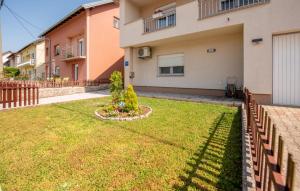 a yard in front of a house with a fence at 1 Bedroom Lovely Apartment In Gracac in Gračac