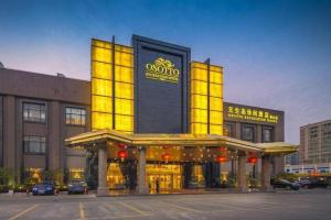a building with yellow lights on top of it at OSOTTO RECREATION HOTEL in Foshan