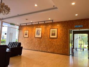 a lobby with a couch and a wall at Cube Plus Signature Hotel OUG Kuala Lumpur in Kuala Lumpur