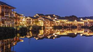 a group of buildings next to a body of water at Grand House Chongqing Dazu Rock Carvings in Dazu