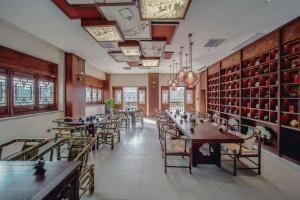 a restaurant with tables and chairs in a room at Grand House Chongqing Dazu Rock Carvings in Dazu