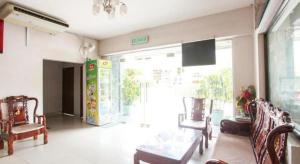 a living room with chairs and a large window at HS Hotel Siswa Near UTAR in Kampar +17 photos