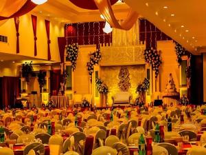 an empty banquet hall with empty tables and chairs at Rama Garden Hotel in Palu