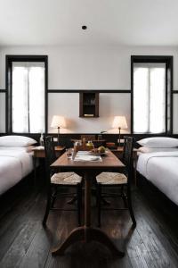 um quarto com uma mesa e cadeiras e duas camas em Humble Hall em Gulang Yu