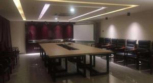 a conference room with a table and chairs and a whiteboard at Jinjiang Inn Select Beijing Miyun Development Zone in Miyun