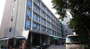 a bus is parked in front of a building at Shenzhen Lavande Hotel Airport Terminal Branch in SZX