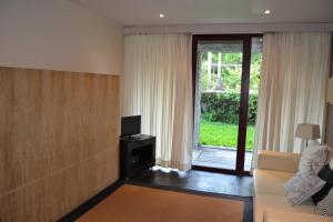 a living room with a couch and a tv and a sliding glass door at Quinta do Mosteiro in Felgueiras +24 photos