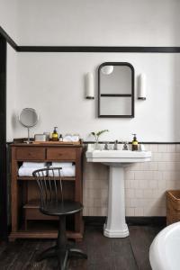 a bathroom with a sink and a chair and a mirror at Humble Hall in Gulang Yu +54 photos