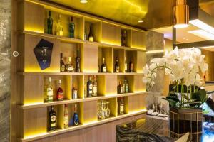 a bar with a bunch of bottles of alcohol at Echarm Hotel Shenyang Nanta Shoe City Army General Hospital in Shenyang
