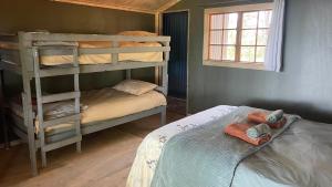 a bedroom with two bunk beds and a bed at Dargle Forest Lodge in Dargle