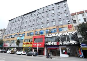 a building on a street with cars parked in front of it at Borrman Hotel Xiamen Xiang'an Maxiang in Xiamen