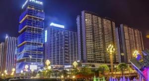 a group of tall buildings in a city at night at Echarm Hotel Guizhou Xingyi Jushan Avenue in Xiawutun