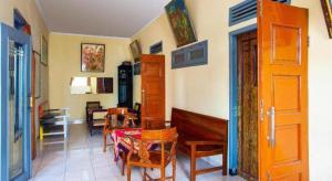 a room with chairs and a bench and a table at SPOT ON 2815 Hotel Damai in Cilacap