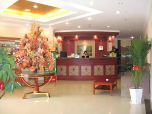 a restaurant with a christmas tree in the lobby at GreenTree Inn Zhenjiang Center Street No.1 Peoples Hospital Express Hotel in Zhenjiang