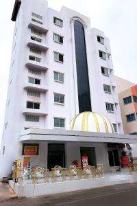 a large white building with chairs in front of it at say hi pattaya hotel in Pattaya Central
