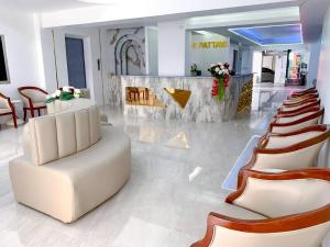 a lobby with a row of chairs and a salon at say hi pattaya hotel in Pattaya