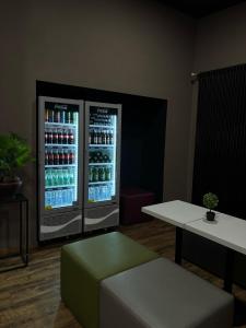a room with a refrigerator with drinks in it at Colour Hotel in Frankfurt