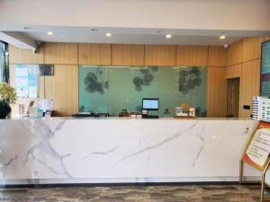 a lobby with a large marble counter top at GreenTree Inn Shanghai Luojing Express Hotel in Shanghai