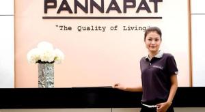 a woman standing in front of a table with a sign at Pannapat Place in Bangkok +156 photos