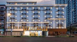 a large blue building with a lot of windows at Jinjiang Inn Hangzhou Lin'an Qianwang Street in Hangzhou