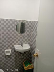 a bathroom with a sink and a mirror at Lapyahan Guest House Room 5 in Lalao