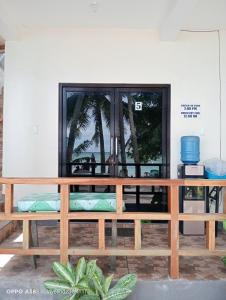 a wooden bench in front of a window at Lapyahan Guest House Room 5 in Lalao