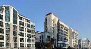 a group of tall buildings in a city at Super 8 Hotel Shanghai Songjiang University Town Branch in Shanghai