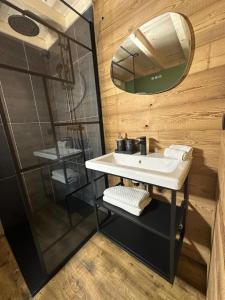 a bathroom with a sink and a shower at Lodge with private spa in Geishouse