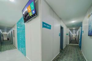 a hallway of a hospital with a tv on the wall at Pai Hotel Guiyang Daximen West Zhongshan Metro Station in Guiyang +82 photos