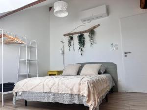 a bedroom with a bed with ivy on the wall at Appartement Ampuis Villa Monplaisir in Ampuis