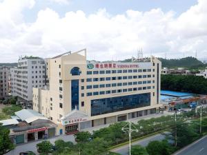 a large building with a sign on top of it at Vienna Hotel Shenzhen Pinghu Shuangyong Street Metro Station in Tiantangwei