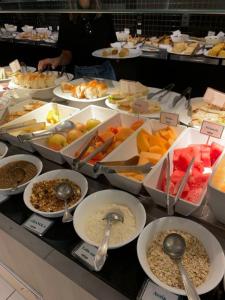 a buffet filled with different types of food with spoons at Khatai Family Hotel & Restaurant in Baku