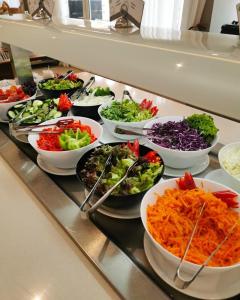 a buffet line with bowls of salads and vegetables at Khatai Family Hotel & Restaurant in Baku +60 photos