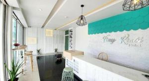 a room with a counter with a sign on the wall at Tiny Krabi Hotel in Ao Nang Beach