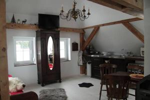 a living room with a teddy bear sitting on a chair at Kleines Schlösschen in Leinau