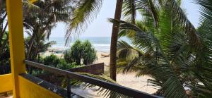 a view of a beach with palm trees and the ocean at Aabhai Beach Resort, Malvan in Malvan
